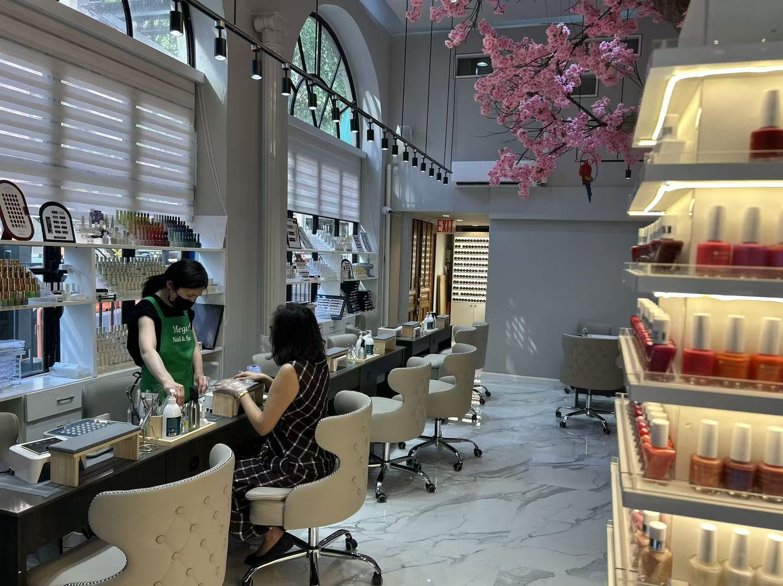 Calm manicure stations under a cherry blossom tree at Mega Japanese Nail in Chelsea, NYC