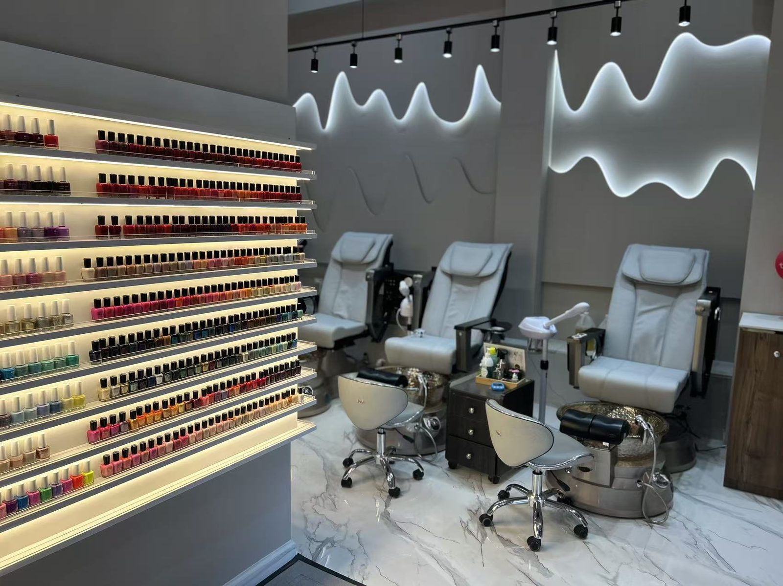 Relaxing spa pedicure chairs and polish wall at Mega Japanese Nail, spa pedicure NYC