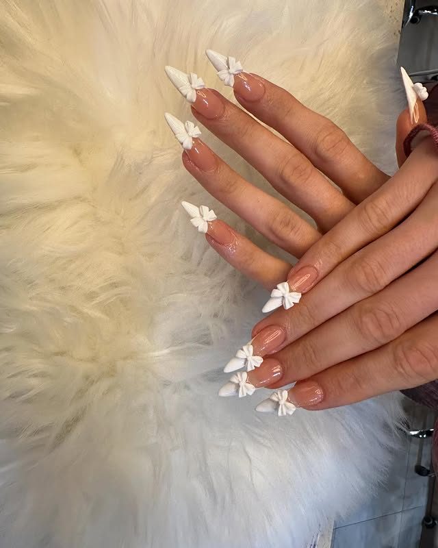 Soft nude nails with delicate 3D bow detail at Mega Japanese Nail, Chelsea NYC