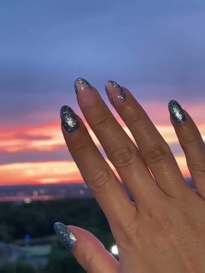 Cat-eye Japanese gel nails photographed against a NYC sunset