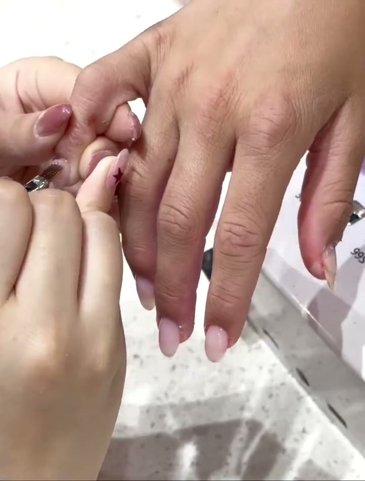 Nail technician applying gel with precision at Mega Japanese Nail Chelsea NYC